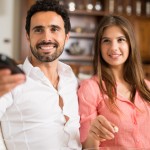 Smiling couple on couch watching television